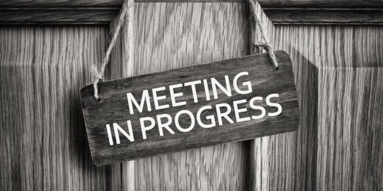 meeting in progress sign